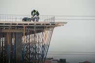 Workers on a high-rise building construction site in Denizli, Türkiye, showcasing teamwork and safety.